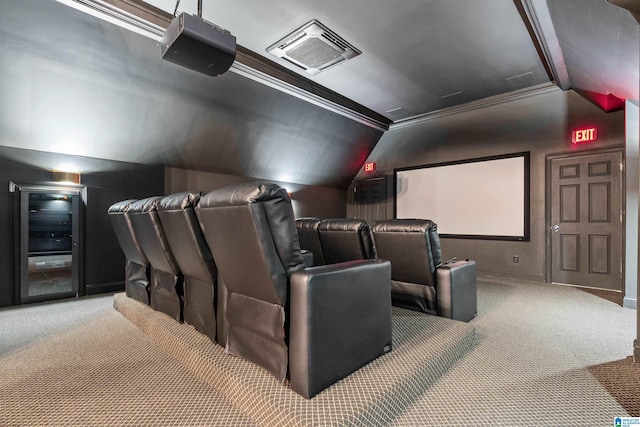 carpeted home theater room featuring lofted ceiling and visible vents