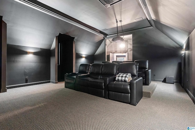 cinema room with lofted ceiling, carpet, baseboards, and crown molding