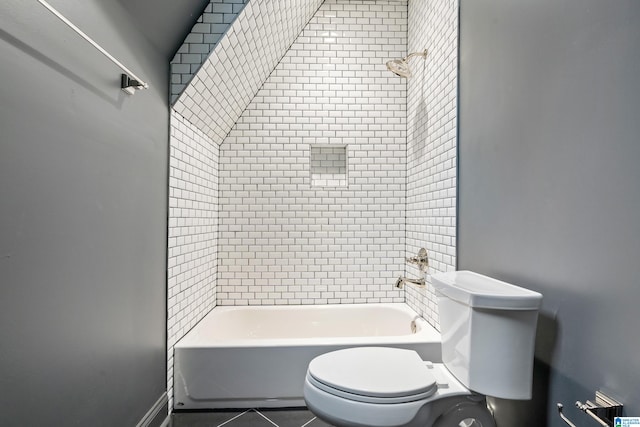 bathroom with toilet, tile patterned flooring, and shower / bathing tub combination