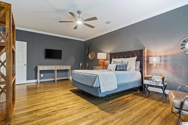 bedroom with ceiling fan, ornamental molding, wood finished floors, and baseboards