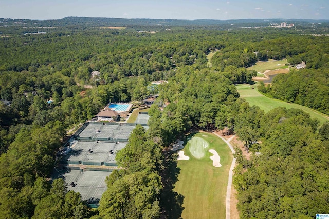 bird's eye view featuring a forest view and golf course view