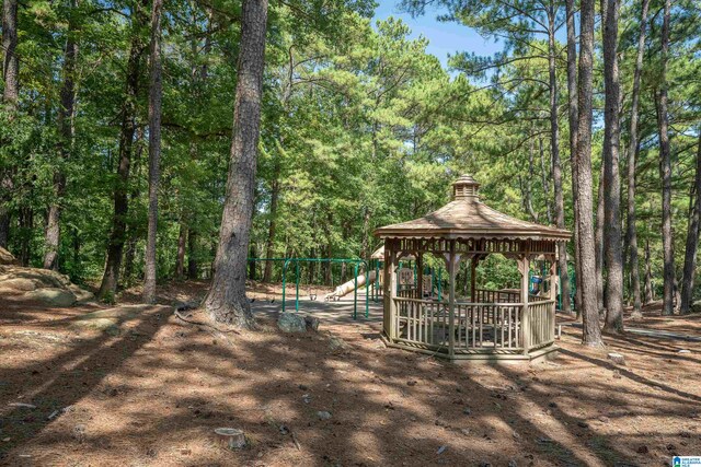 view of play area with a gazebo and a wooded view