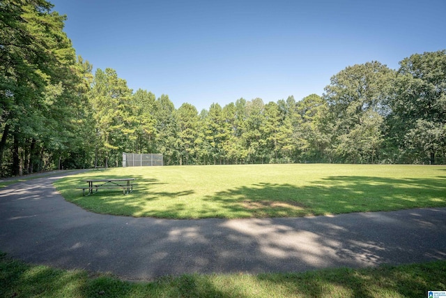 view of home's community featuring a yard and a wooded view