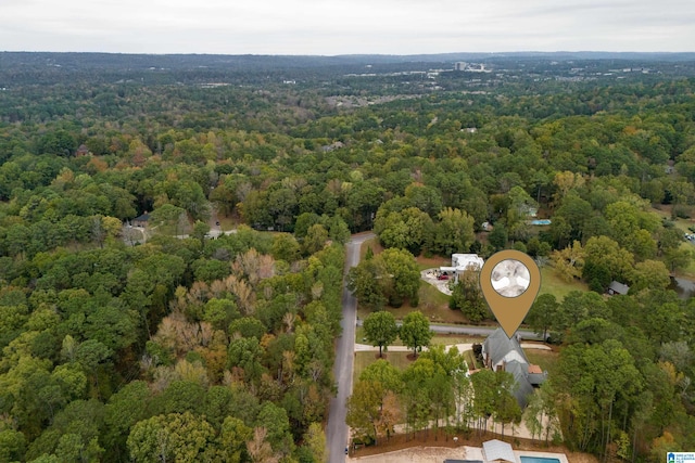 aerial view featuring a wooded view