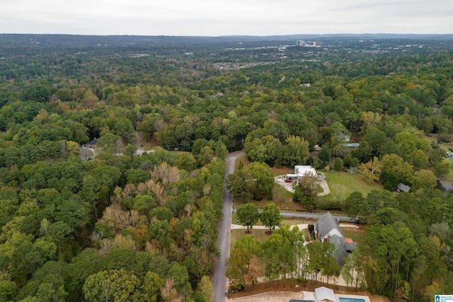 drone / aerial view featuring a forest view