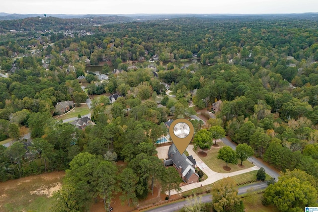 birds eye view of property with a view of trees