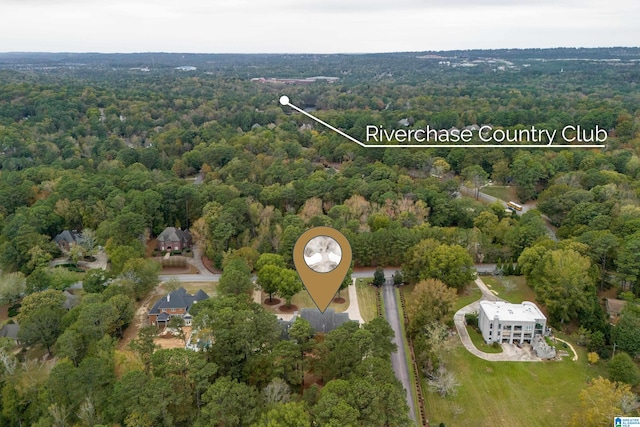 bird's eye view with a wooded view