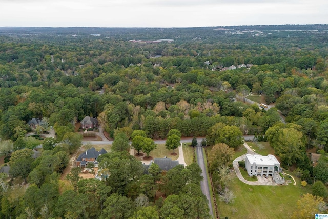 birds eye view of property with a view of trees