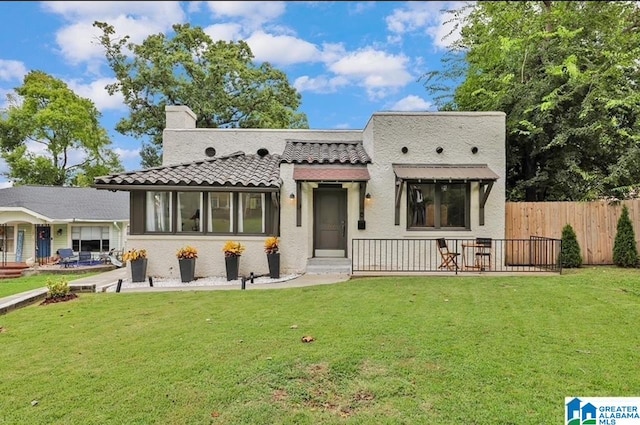 rear view of house with a yard