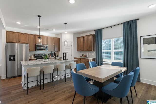 dining space featuring sink and dark hardwood / wood-style floors