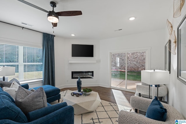 living room featuring ceiling fan and light hardwood / wood-style flooring