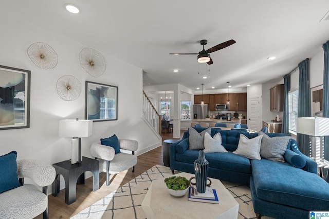 living room with light wood-type flooring and ceiling fan