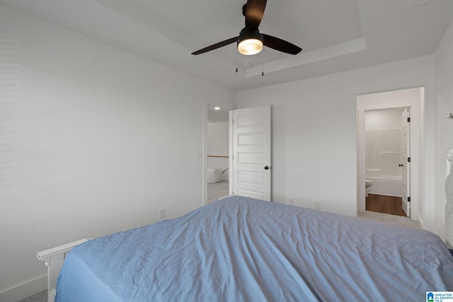 bedroom featuring carpet floors, connected bathroom, and ceiling fan