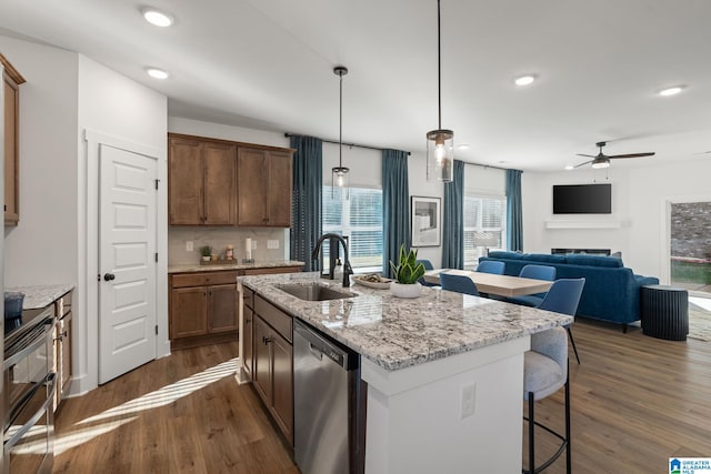 kitchen featuring a healthy amount of sunlight, appliances with stainless steel finishes, sink, and pendant lighting