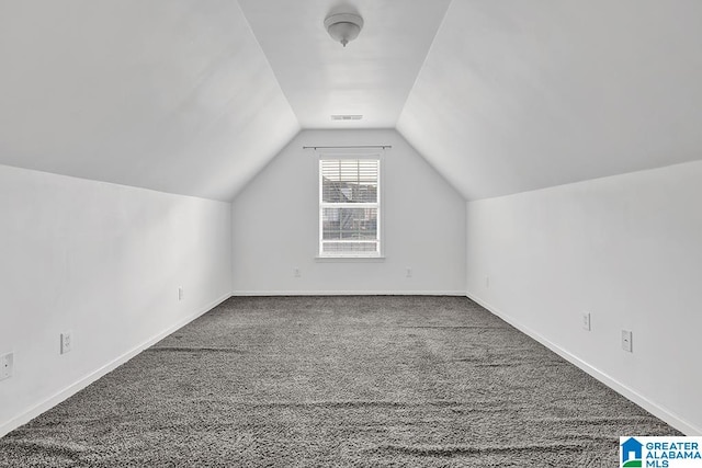 bonus room featuring lofted ceiling and carpet flooring