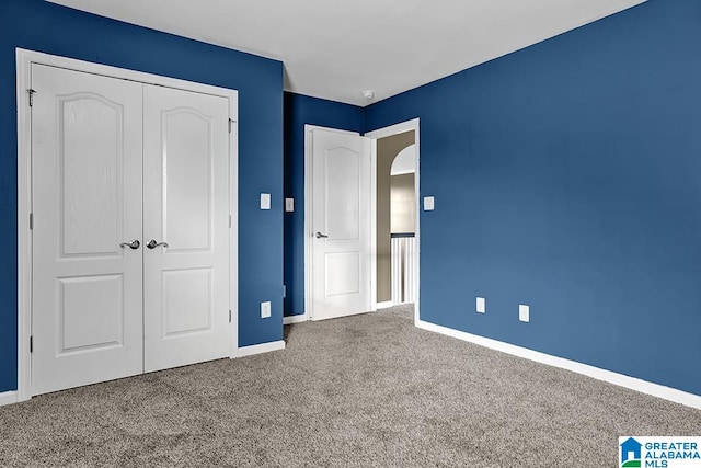 unfurnished bedroom featuring a closet and carpet