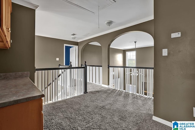 hall with crown molding and carpet floors