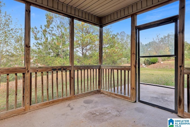 unfurnished sunroom with wood ceiling