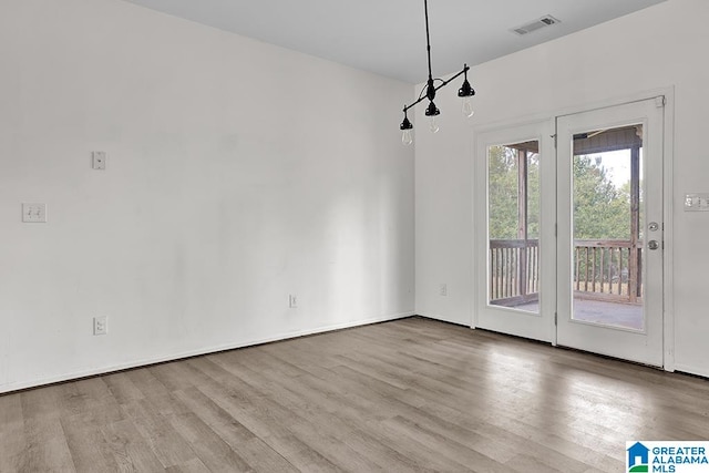 unfurnished dining area with light hardwood / wood-style flooring