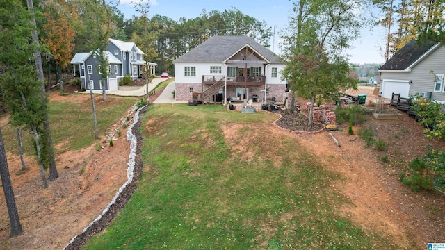 back of house with covered porch and a lawn