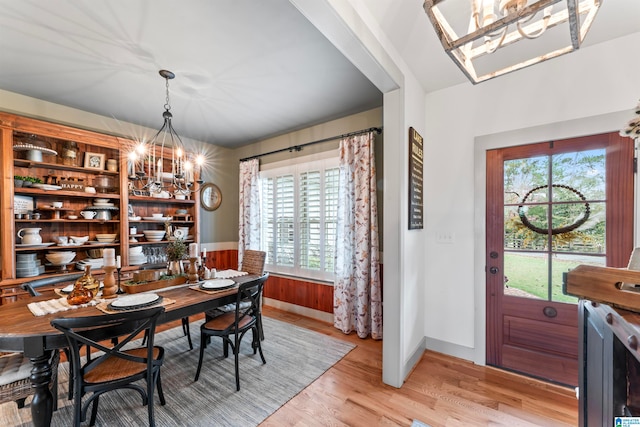 dining area with an inviting chandelier and light wood-type flooring