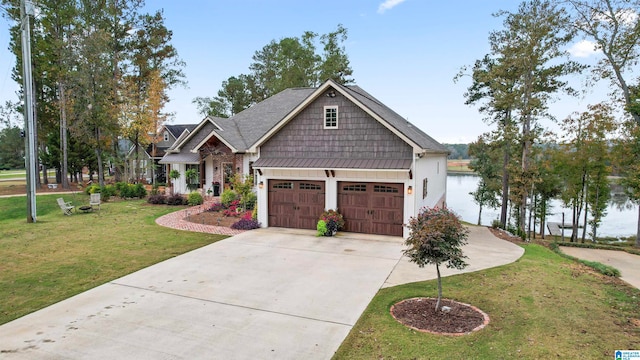 craftsman house featuring a water view, a front yard, and a garage