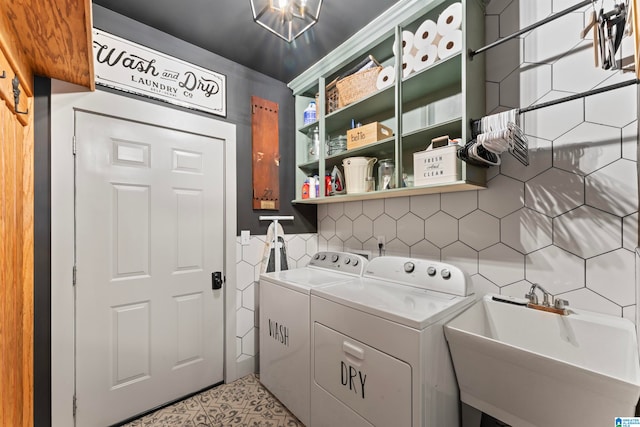 washroom with sink and washer and clothes dryer