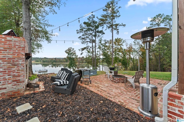 view of yard with a water view, a patio area, and an outdoor fire pit