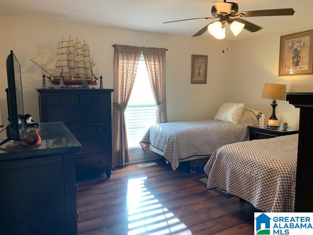 bedroom featuring dark wood-type flooring and ceiling fan