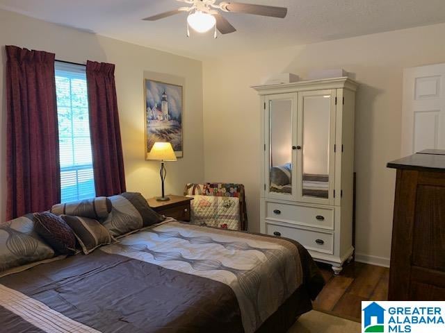 bedroom featuring dark hardwood / wood-style flooring and ceiling fan