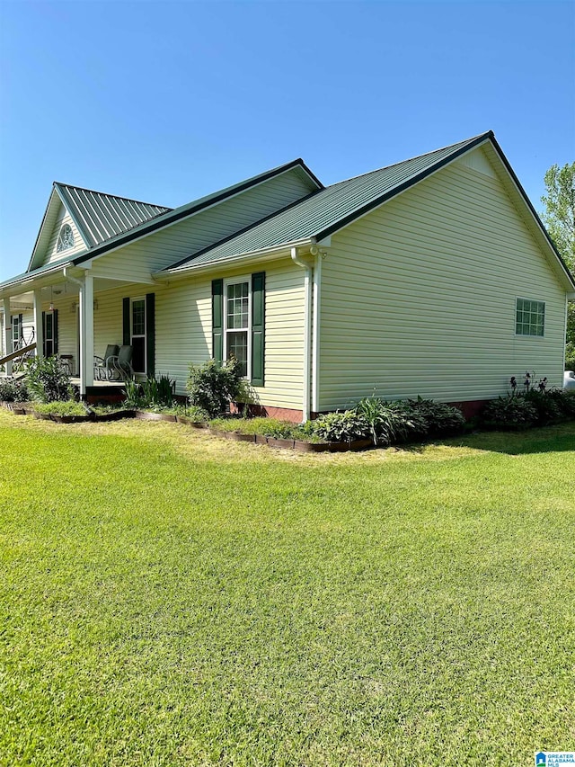 view of property exterior with a yard and a porch