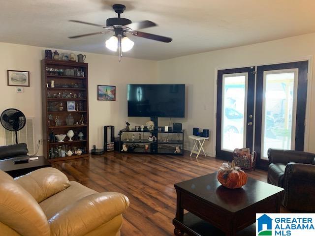 living room featuring french doors, hardwood / wood-style flooring, and ceiling fan