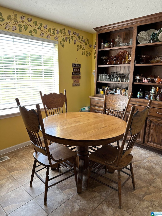 dining space featuring a textured ceiling