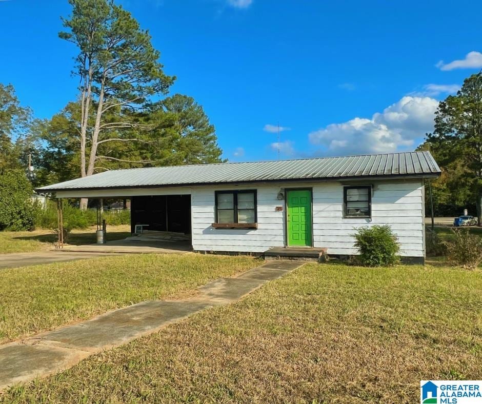 ranch-style home with a front yard and a carport