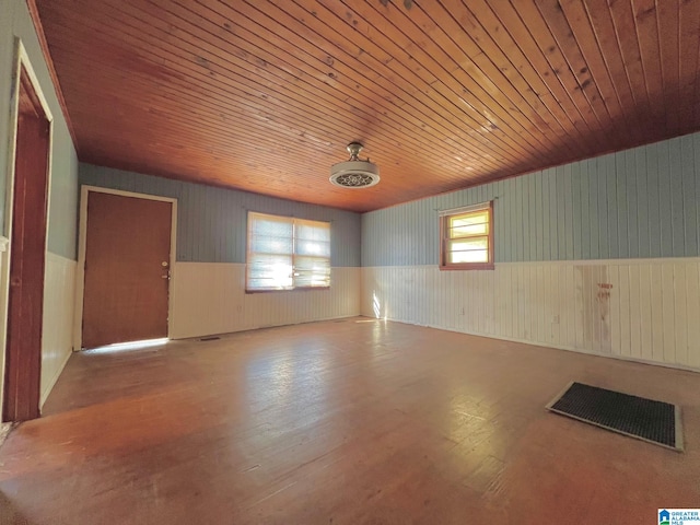 unfurnished room featuring wood walls, light hardwood / wood-style floors, and wooden ceiling