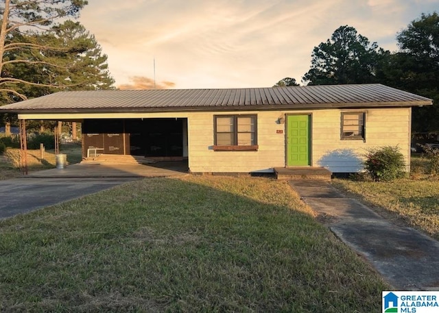 ranch-style house with a yard and a garage