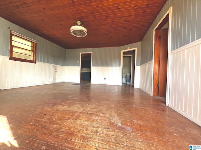 spare room featuring dark hardwood / wood-style flooring, wood walls, and wooden ceiling