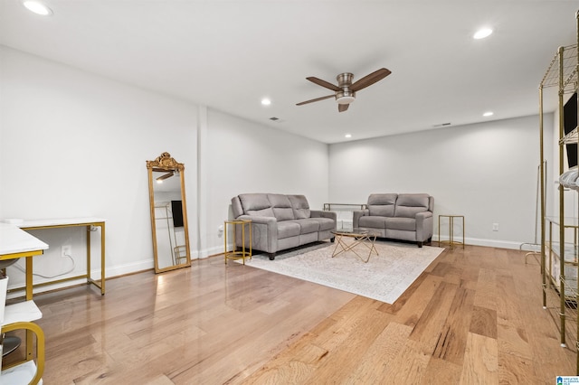 living room featuring light wood-type flooring and ceiling fan