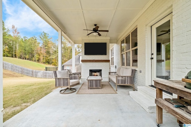 view of patio featuring an outdoor brick fireplace and ceiling fan