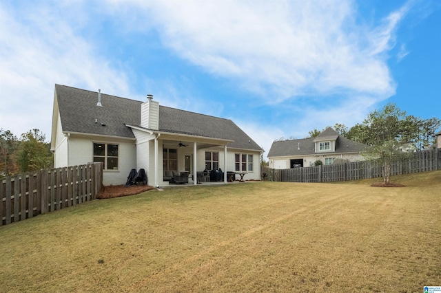 back of property featuring ceiling fan, a lawn, and a patio area