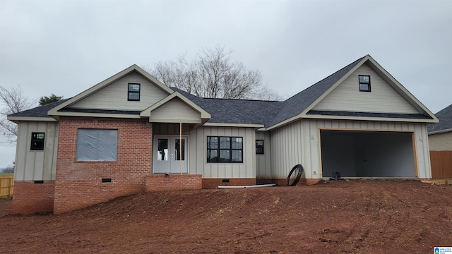 modern farmhouse style home featuring crawl space, board and batten siding, entry steps, a garage, and a shingled roof
