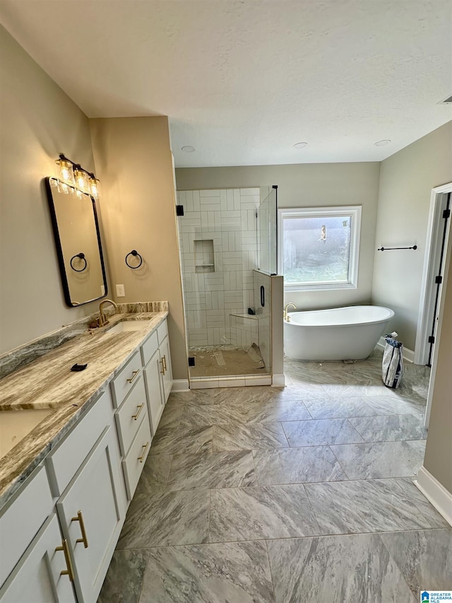 bathroom featuring a freestanding tub, baseboards, double vanity, and a stall shower