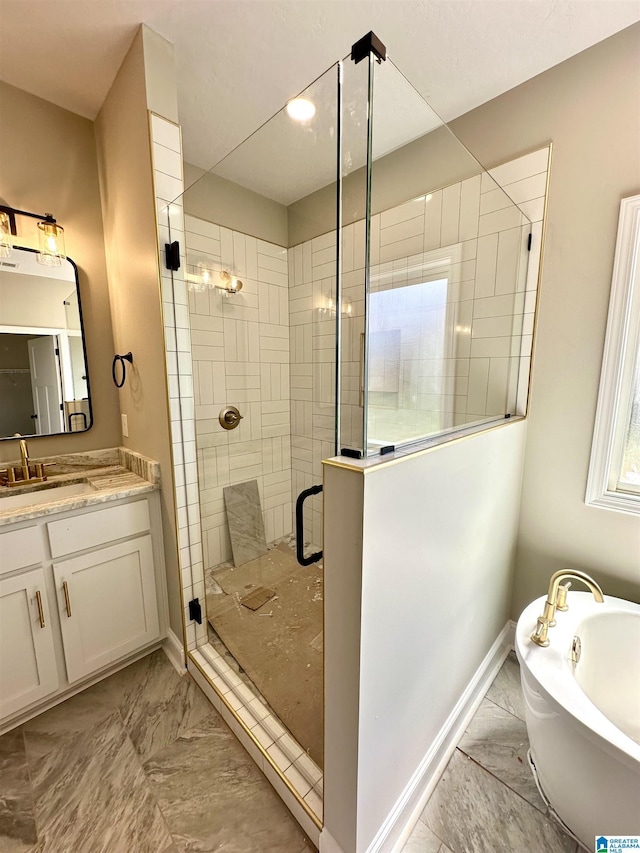 bathroom with vanity, marble finish floor, a freestanding bath, a stall shower, and baseboards