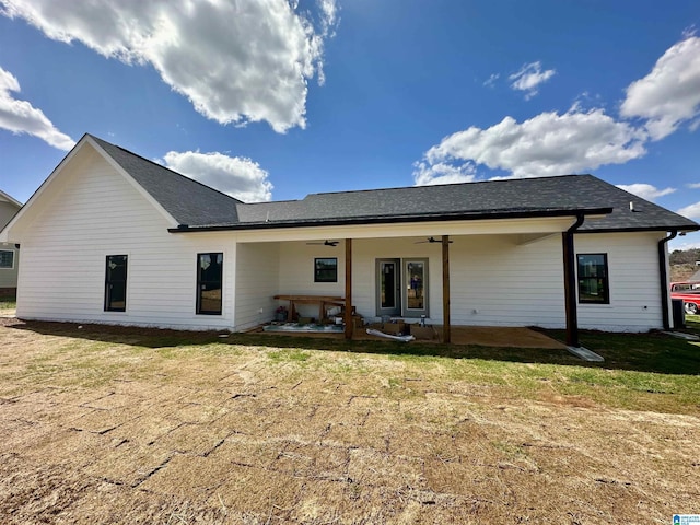 rear view of property with a patio area, a yard, and ceiling fan