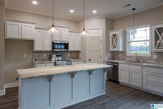 kitchen with stainless steel appliances, tasteful backsplash, dark hardwood / wood-style floors, and white cabinets