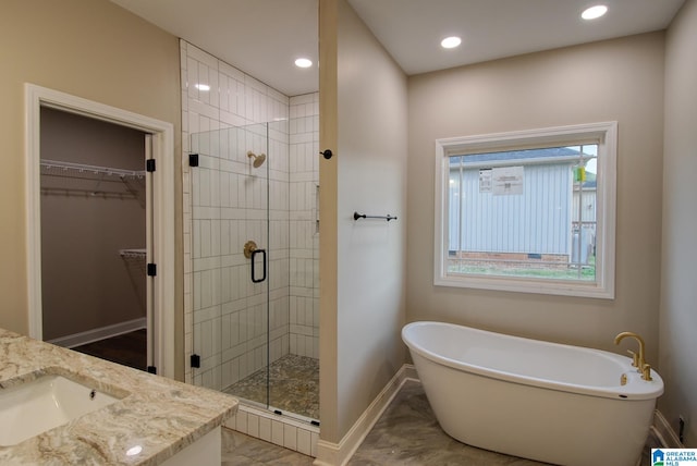 bathroom featuring vanity and shower with separate bathtub