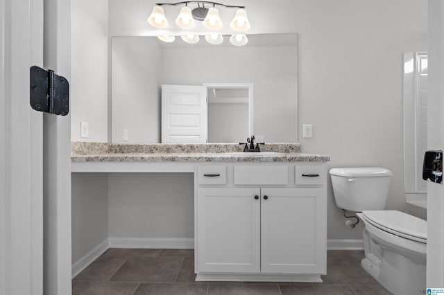 bathroom featuring tile patterned floors, vanity, and toilet