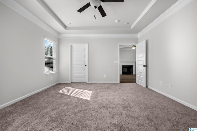 unfurnished bedroom featuring ceiling fan, carpet, and ornamental molding