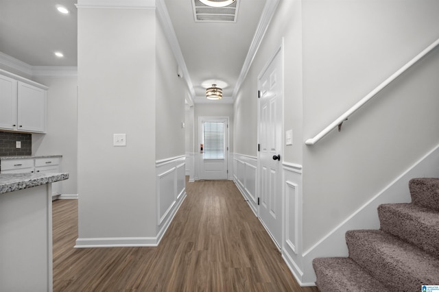 corridor featuring dark hardwood / wood-style flooring and crown molding