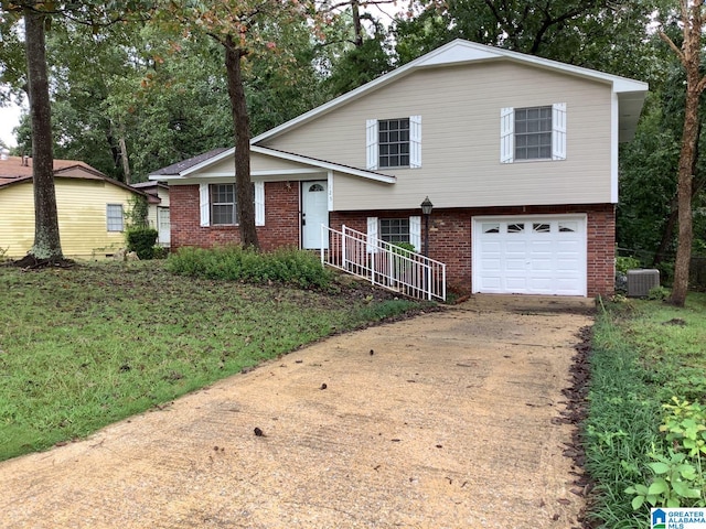 tri-level home featuring cooling unit and a garage